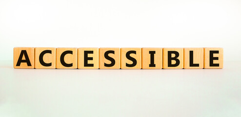 Accessible symbol. The word accessible on wooden cubes. Beautiful white table, white background. Business and accessible concept. Copy space.