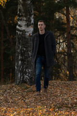 a man walking in the autumn forest