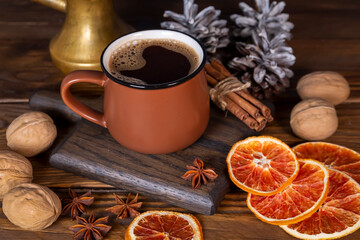 A cup of coffee among the Christmas decorations. Celebrating Christmas and New Years. Home comfort.