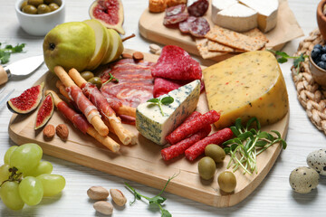 Set of different delicious appetizers served on white wooden table
