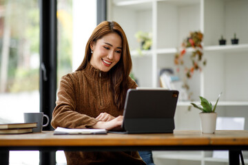 Professional young asian business woman using computer laptop and Talking On Phone Working On Laptop In Modern Office.	