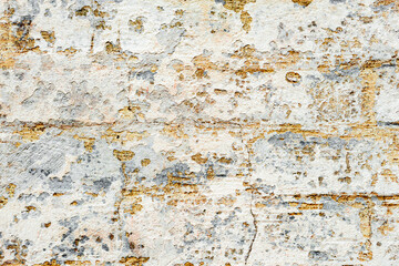 Texture of a brick wall with cracks and scratches which can be used as a background