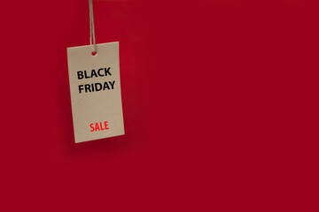 Price tag on a red background with the inscription Black Friday Sale. Copy space for text