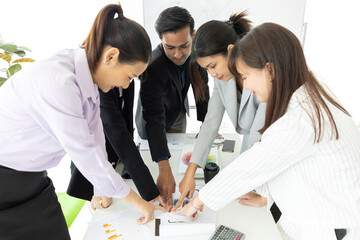 group of businesspeople team meeting and brainstorming works pointing to document on the table in conference room