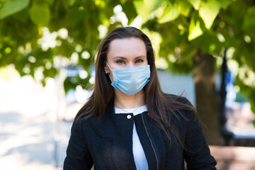 Portrait of Caucasian brunette girl in medical mask. Hygiene, protection against pneumonia, coronavirus, covid19.