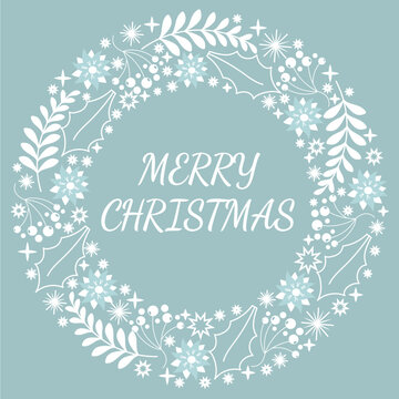 MErry christmas text in wreath made from ornaments in blue and white colors.Winter holidays concept.POstcard