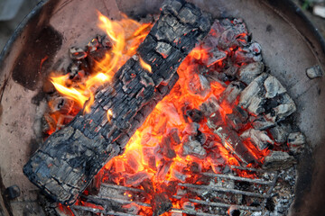 Barbecue flaming Charcoal Grill close up photo. Cooking outdoor. Beautiful flames of fire. 