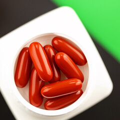 red medical pills close-up. immune prevention care concept. dietary supplement selective focus photo