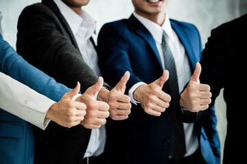 Teamwork of businessman thump up. Group of smiling young multi ethnic business people enjoying and showing gesture cool thumbs up. Team work, corporate, success concept.