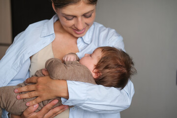 Obraz na płótnie Canvas Attractive happy mother holding little baby girl. Happy family