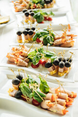 Sandwiches, canapes and cakes on the festive table. A wide variety of snacks