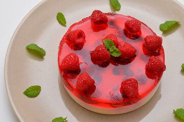 cheesecake decorated with raspberries and mint close-up