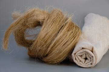 Fibers of natural uncolored flax, tow. Roll of linen fabric. Growing demand for natural fibers.