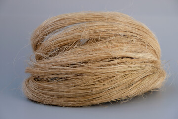 Fibers of natural uncolored flax or hemp, tow, close-up. Growing demand for natural fibers. 