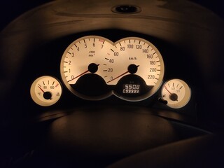 Front view of a car dashboard modern automobile control illuminated speed panel display, car speedometer, speed meter.