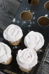 Homemade marshmallows. Marshmallow in a waffle cone on a counter for making. Made in the shape of a rose. Close-up shot.