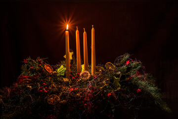 first burning candle on advent wreath