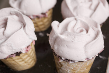 Homemade marshmallows. Marshmallow in a waffle cone on a counter for making. Made in the shape of a rose. Close-up shot.