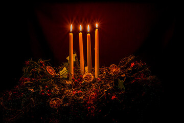 four burning candles on advent wreath
