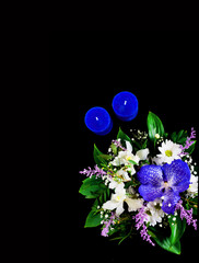 Trendy bouquet with flower of blue classic color on dark background. Romantic background with candles. Copy space