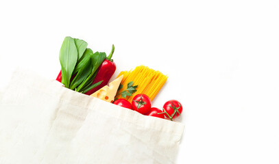 Eco bag with vegetables and spaghetti on white background. Ingredients for cooking. Close-up