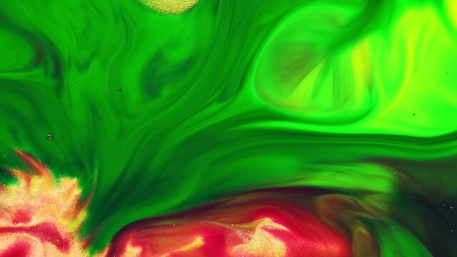 Deep green and yellow inks interact with each other to create abstract shapes, swirls, and splash. Screensaver for advertising or background display colors. Deep ink space.