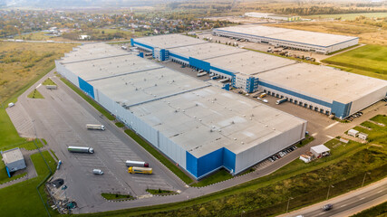 Aerial view of big storage and freight terminal with trucks. Warehouse aerial view.