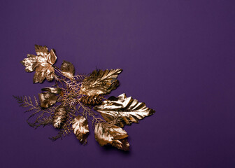 Purple and gold composition. Foliage against dark violet background. Power and nobility theme. 