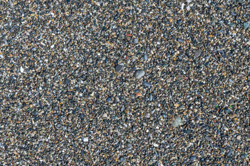 sea beach of small multi-colored pebbles as a natural background