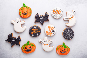 Halloween gingerbread cookies on stone background. Bright homemade cookies for Halloween party