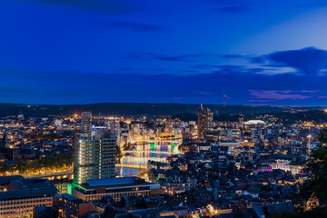 HDR Panorama with an amazing view over the Belgium city of Liege during a colourful sunset and in the background a dramatic sky with clouds full of heavy rain.