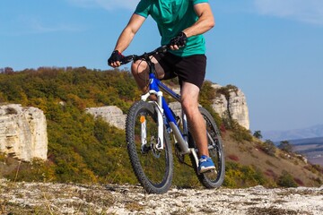 Fototapeta premium Cyclist Riding the Bike on the Beautiful Spring Mountain Trail