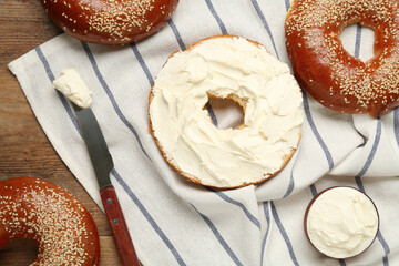 Delicious bagel with cream cheese on table, flat lay - obrazy, fototapety, plakaty