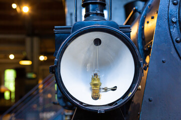 Details of a rare steam locomotive in the museum. Spotlight lighting