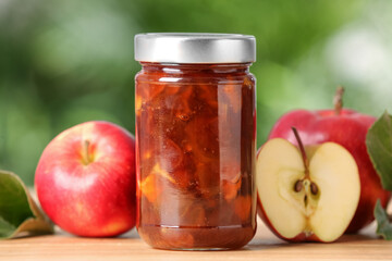 Delicious apple jam and fresh fruits on wooden table