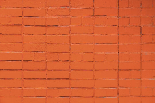 matte orange painted brick wall full frame flat background and texture