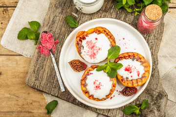 Grilled peach with yogurt, mint, and sweet pink sugar. Useful breakfast concept, healthy food