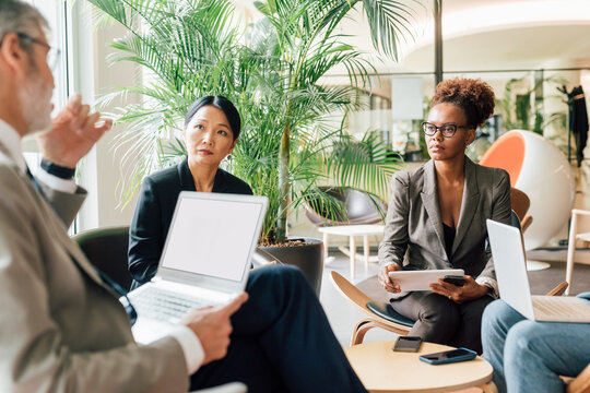 Italy, Business people having meeting in creative studio