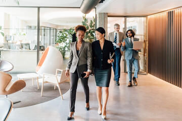 Italy, Business people walking in creative studio