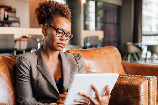 Italy, Businesswoman using digital tablet in creative studio