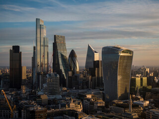 UK, London, Aerial view of financial district skyscrapers at sunset