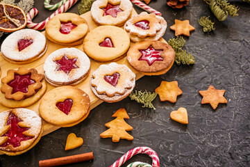 Homemade Christmas cookies with raspberry jam. Traditional Linzer cookies on a dark table, copy space