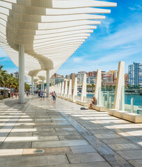 Beautiful gallery in Malaga harbour on a sunny summer day, Spain.