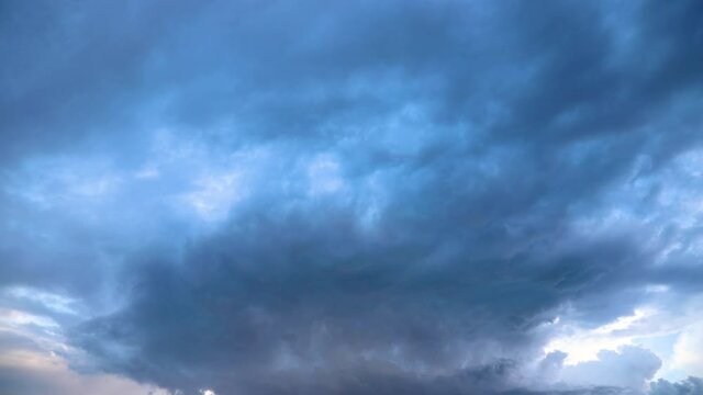 timelapse with beautiful darkness clouds and a small rainbow between they