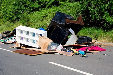 Rubbish dumped on a country lane. Fly-tipping causes environmental pollution. Fly Tipping