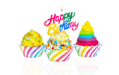 Three isolated cupcakes with a candle on a white background