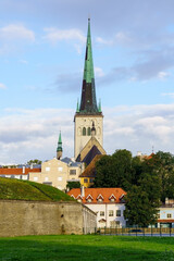 Medieval cathedral church sticking out of the roofs of the houses.