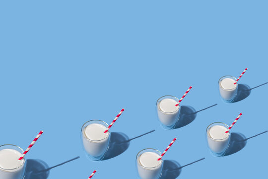 World Milk Day. Glass of milk with a red straw against a blue background. Seamless pattern. Sample. Package. - Powered by Adobe