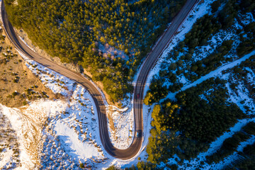 Kopaonik mountain range in Serbia. Aerial view on Kopaonik National Park. Sunset under mountains, hills and meadows. Winding road along the mountains