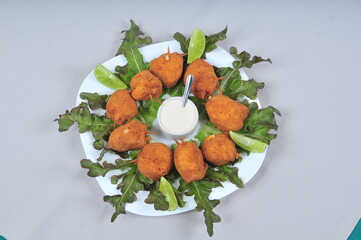 delicious fried bacalhau potato and cassava dumpling, baked and stuffed with chicken, cheese, olives and cream, kieve